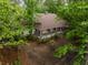 Charming home featuring a inviting covered porch, nestled among mature trees for serene and private outdoor living at 8315 Nicholson Rd, Cumming, GA 30028