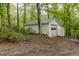 Detached garage with vinyl siding, concrete driveway and green surroundings at 8315 Nicholson Rd, Cumming, GA 30028