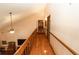 Hallway with railing overlooks living room with vaulted ceiling, and ceiling fan at 8315 Nicholson Rd, Cumming, GA 30028