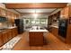 Spacious kitchen with wood cabinets, central island, and large windows offering an outdoor view at 8315 Nicholson Rd, Cumming, GA 30028
