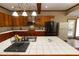 Open kitchen with stainless steel appliances, tiled countertops, and wood cabinets at 8315 Nicholson Rd, Cumming, GA 30028