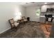 Cozy kitchenette with modern appliances, grey cabinets, and an adjacent seating area for relaxing or dining at 8315 Nicholson Rd, Cumming, GA 30028