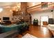 Open-concept living area with brick fireplace, wooden floors, and abundant natural light at 8315 Nicholson Rd, Cumming, GA 30028