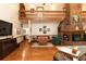 Comfortable living room with brick fireplace, wooden floors, and natural lighting at 8315 Nicholson Rd, Cumming, GA 30028