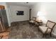Open living area with kitchenette, decorative carpeting, and stainless-steel appliances for seamless living and entertaining at 8315 Nicholson Rd, Cumming, GA 30028