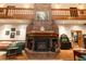 Spacious living room featuring a striking brick fireplace and wooden accents at 8315 Nicholson Rd, Cumming, GA 30028