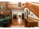 Bright living room featuring wooden floors, a fireplace, and an open layout at 8315 Nicholson Rd, Cumming, GA 30028