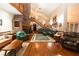 Inviting living area with hardwood floors, cozy seating, and a brick fireplace feature at 8315 Nicholson Rd, Cumming, GA 30028