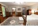 Bright main bedroom features hardwood floors, a ceiling fan, and multiple doorways at 8315 Nicholson Rd, Cumming, GA 30028