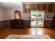 Main bedroom showcasing hardwood floors, built-ins, and patio doors with backyard access at 8315 Nicholson Rd, Cumming, GA 30028