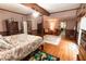 Spacious main bedroom with hardwood floors, four-poster bed and exposed beam ceiling at 8315 Nicholson Rd, Cumming, GA 30028