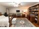 Expansive main bedroom includes wood floors, a ceiling fan, a bookshelf, and warm decor at 8315 Nicholson Rd, Cumming, GA 30028