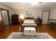 Inviting main bedroom offers hardwood floors and vintage furnishings throughout at 8315 Nicholson Rd, Cumming, GA 30028