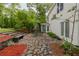 Back patio features a stone patio and outdoor dining area, perfect for enjoying the landscaped yard at 8315 Nicholson Rd, Cumming, GA 30028