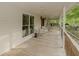 Spacious covered porch offering a peaceful spot with ample seating to enjoy the surrounding natural beauty at 8315 Nicholson Rd, Cumming, GA 30028