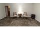 Comfortable sitting area with neutral walls, decorative carpet, two chairs, and a lamp table at 8315 Nicholson Rd, Cumming, GA 30028