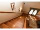 A well-lit stairway featuring wood steps, handrail, and a view of the living area at 8315 Nicholson Rd, Cumming, GA 30028