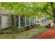 Sunroom leads to a stone patio and seating area, offering a seamless transition to outdoor living at 8315 Nicholson Rd, Cumming, GA 30028