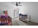 Bedroom featuring a ceiling fan, carpet, and an exterior door at 105 Olde Mill Ln, Norcross, GA 30093