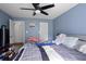 Cozy bedroom features a ceiling fan, and soft blue walls offering a relaxing retreat at 105 Olde Mill Ln, Norcross, GA 30093
