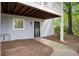 Charming condo entrance with a gray door, white trim, and a well-maintained sidewalk and mulched area at 105 Olde Mill Ln, Norcross, GA 30093