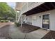 Ground-level condo entrance featuring a black door and trimmed landscaping with walkway at 105 Olde Mill Ln, Norcross, GA 30093