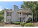 Attractive two-story condo with gray siding, white trim, and lush landscaping creates a welcoming curb appeal at 105 Olde Mill Ln, Norcross, GA 30093