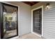 Exterior shows back entrance with black framed doors and gray siding near porch area at 105 Olde Mill Ln, Norcross, GA 30093