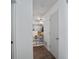 Hallway leading to the kitchen with a safety gate and neutral color palette at 105 Olde Mill Ln, Norcross, GA 30093