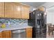 Bright kitchen area with modern appliances, tile backsplash and laminate floors at 105 Olde Mill Ln, Norcross, GA 30093