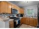 Well-lit kitchen featuring stainless steel appliances, a mosaic backsplash, and ample wooden cabinetry at 105 Olde Mill Ln, Norcross, GA 30093