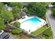 Aerial view of a large community pool with lounge chairs and a gazebo, surrounded by mature trees at 105 Olde Mill Ln, Norcross, GA 30093