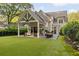 Backyard view shows patio with seating, dining area, and spacious lawn, perfect for outdoor gatherings and relaxation at 1201 Beech Valley Ne Rd, Atlanta, GA 30306