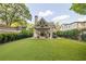 A spacious backyard includes a covered patio with furniture and dining area, surrounded by a well-maintained lawn at 1201 Beech Valley Ne Rd, Atlanta, GA 30306