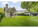 Large, well-maintained backyard features a covered patio with seating, dining area, and a lush green lawn at 1201 Beech Valley Ne Rd, Atlanta, GA 30306
