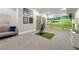 Spacious basement golf simulator room featuring a comfortable seating area and golf bag at 1201 Beech Valley Ne Rd, Atlanta, GA 30306