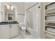 Clean bathroom with shower and tub combination, white tiled walls, and storage shelves at 1201 Beech Valley Ne Rd, Atlanta, GA 30306