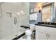 Modern bathroom with marble tiled shower, contrasting fixtures and blue wallpaper at 1201 Beech Valley Ne Rd, Atlanta, GA 30306