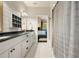 Bright bathroom featuring white cabinets, a gray countertop and a white tile floor at 1201 Beech Valley Ne Rd, Atlanta, GA 30306
