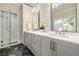 Bathroom featuring double vanity, marble countertop, modern fixtures, and a glass-enclosed shower at 1201 Beech Valley Ne Rd, Atlanta, GA 30306