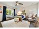 Cozy bedroom featuring a ceiling fan, large windows, and sports-themed decor at 1201 Beech Valley Ne Rd, Atlanta, GA 30306