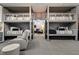 Bunk room with four gray bunks and comfortable seating area in a rec room setting at 1201 Beech Valley Ne Rd, Atlanta, GA 30306
