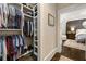 Walk-in closet with custom shelving, hanging rods, and views into the main bedroom at 1201 Beech Valley Ne Rd, Atlanta, GA 30306