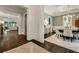 Elegant dining room with hardwood floors, a patterned wallpaper, coffered ceiling, and views to the living room at 1201 Beech Valley Ne Rd, Atlanta, GA 30306
