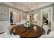 Well-appointed dining room featuring a wooden table, six chairs, and stylish chandelier, perfect for entertaining at 1201 Beech Valley Ne Rd, Atlanta, GA 30306
