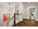 Open hallway with beautiful hardwood floors, decorative lighting, and a view into other rooms at 1201 Beech Valley Ne Rd, Atlanta, GA 30306