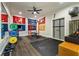 Well-equipped home gym with weights, training equipment, and university sports flags at 1201 Beech Valley Ne Rd, Atlanta, GA 30306