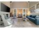 Bright living room with fireplace, blue sofa and adjacent seating, and natural light at 1201 Beech Valley Ne Rd, Atlanta, GA 30306