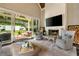 Sun-filled living room featuring a brick fireplace, large screen tv and sliding doors to the backyard at 1201 Beech Valley Ne Rd, Atlanta, GA 30306