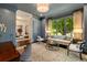Stylish living room with large window, hardwood flooring, and an open doorway into an adjacent formal dining room at 1201 Beech Valley Ne Rd, Atlanta, GA 30306